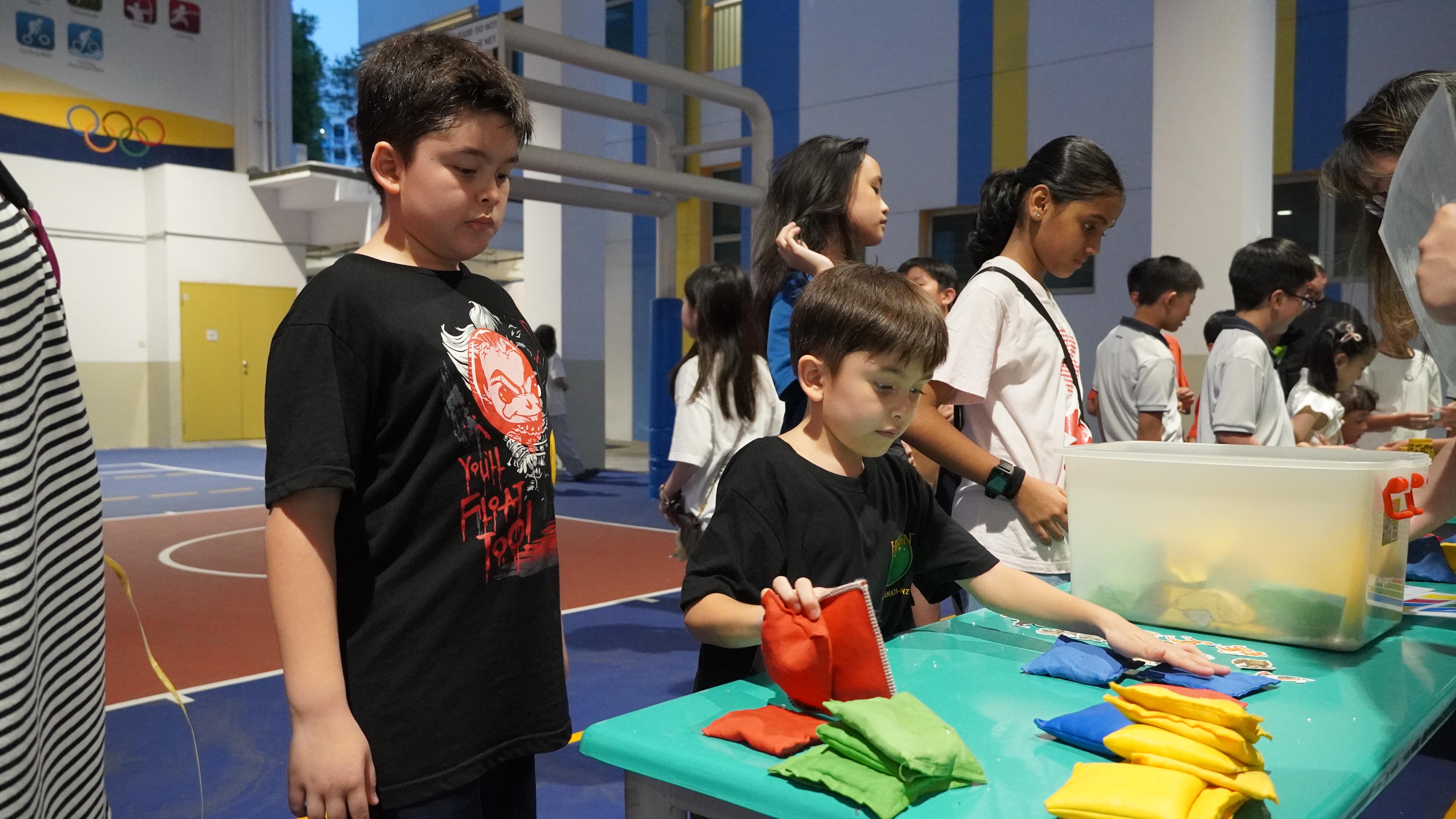 It’s all about concentration and coordination as participants take on the beanbag challenge.